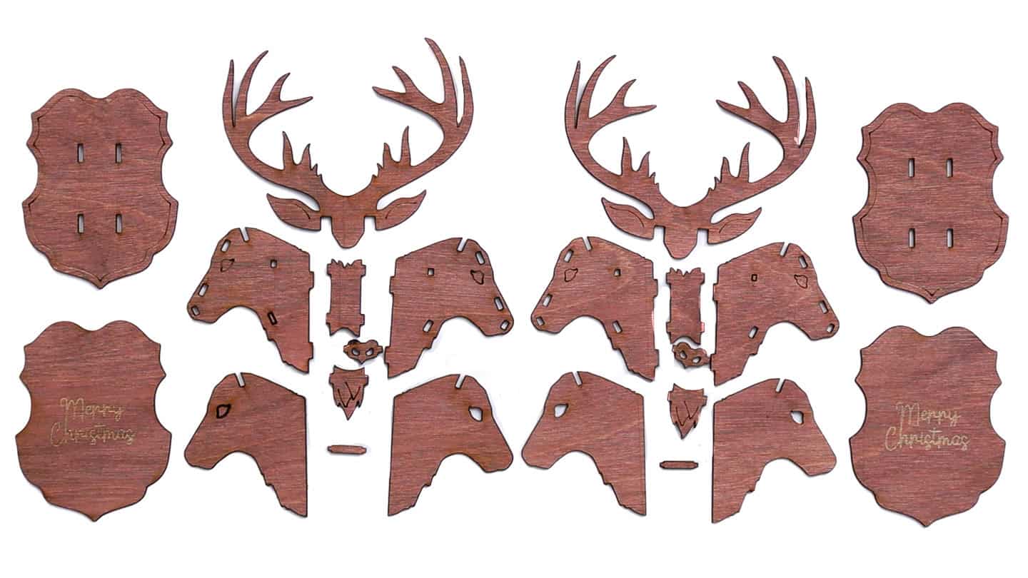 Laser-cut wooden reindeer ornament pieces laid out flat, including antlers, head sections, mounts, and small connecting parts.