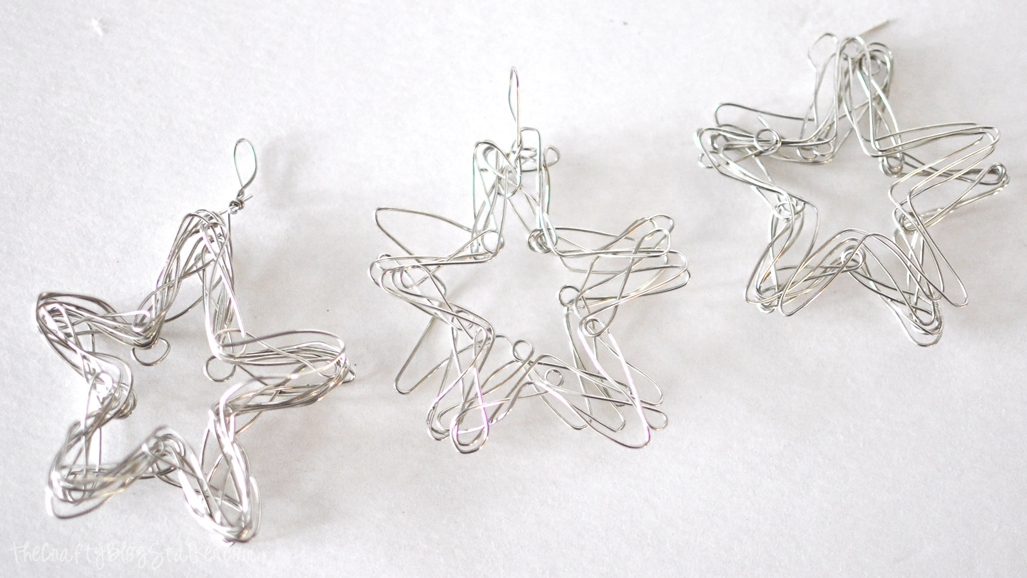 Three handmade wire star ornaments in different shapes and thicknesses displayed on a white background.
