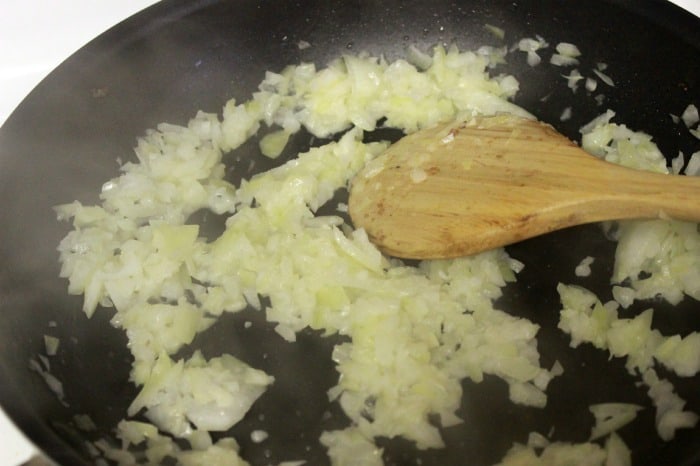 Cooking onions and garlic in a frying pan.