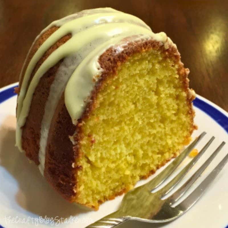 A slice of lemon bundt cake on a plate with a fork.