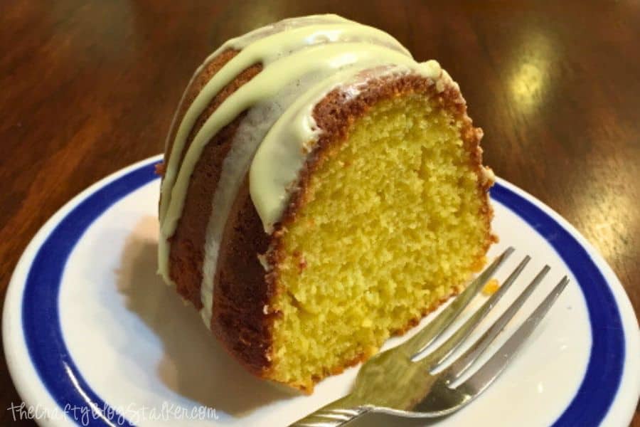 A slice of lemon bundt cake on a plate with a fork.