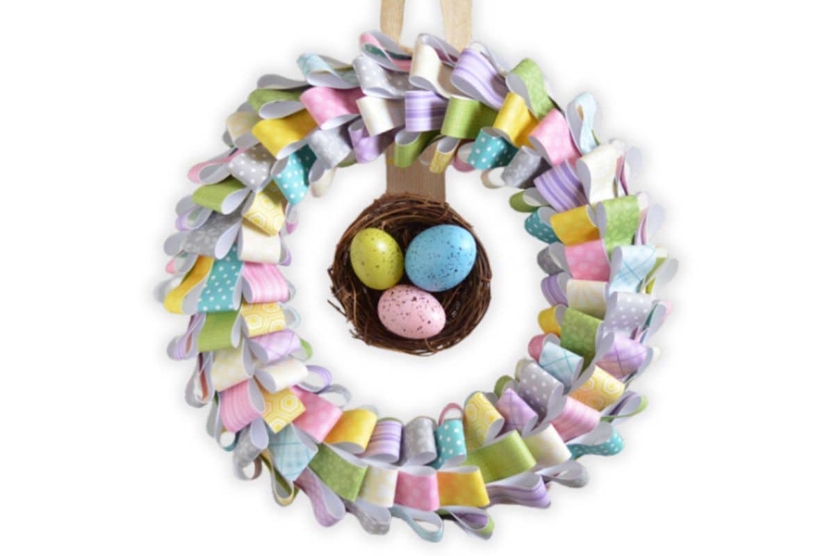 Scrap pattern paper easter wreath with speckled eggs in the center.
