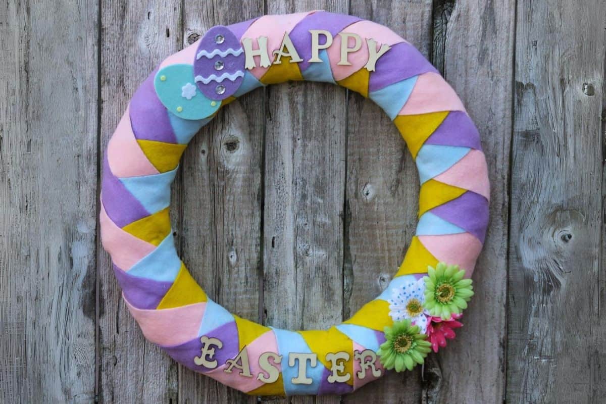 diy felt easter wreath made with pink, purple, blue and yellow craft felt.