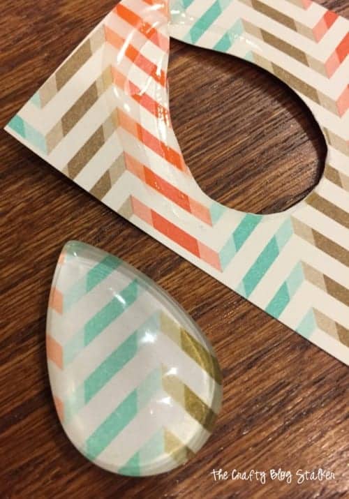 image of glass pendant cut out of patterned paper