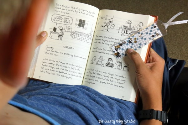 a child reading holing his shaker bookmark