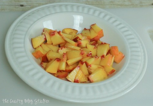 image of a cut up peach in a bowl