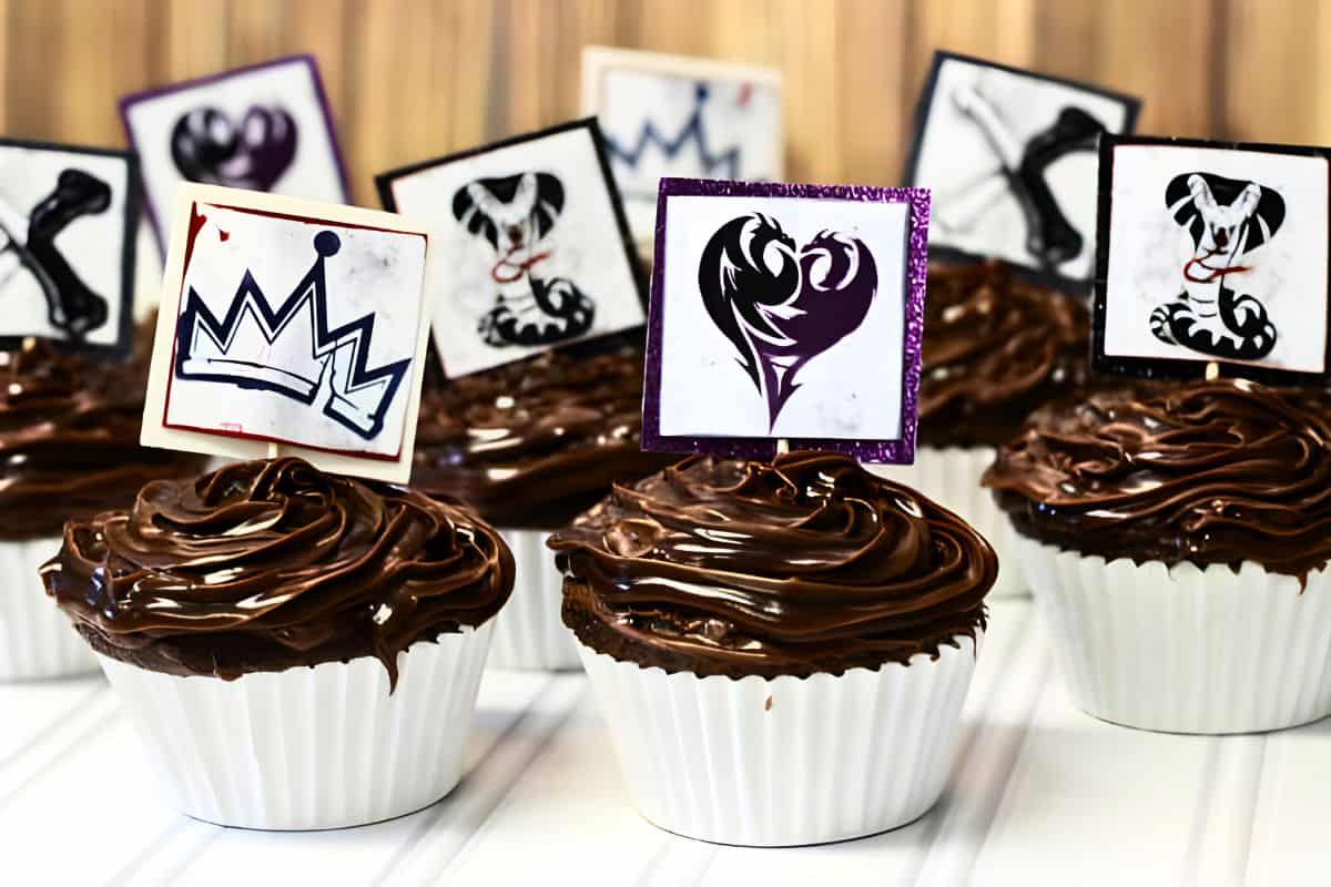 Chocolate cupcakes with Disney Descendants cupcake toppers.