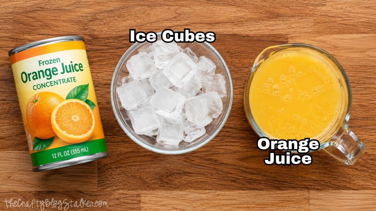 Orange juice slushie ingredients including frozen orange juice concentrate, a bowl of ice cubes, and a glass of orange juice.