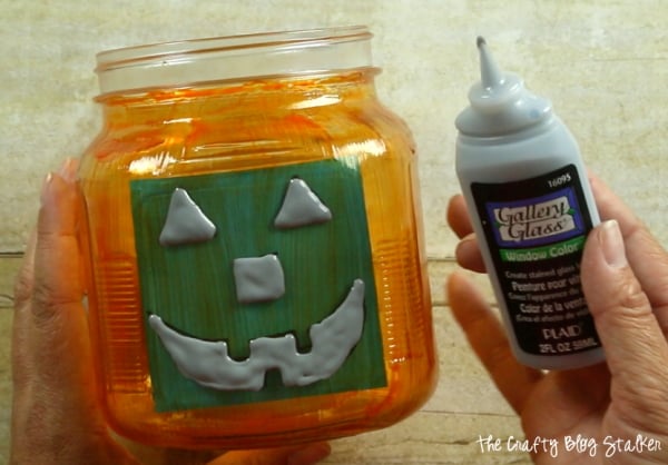 tracing the jack o lantern face with black gallery glass paint