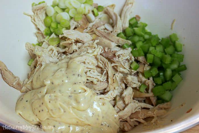 chicken salad ingredients in a white bowl