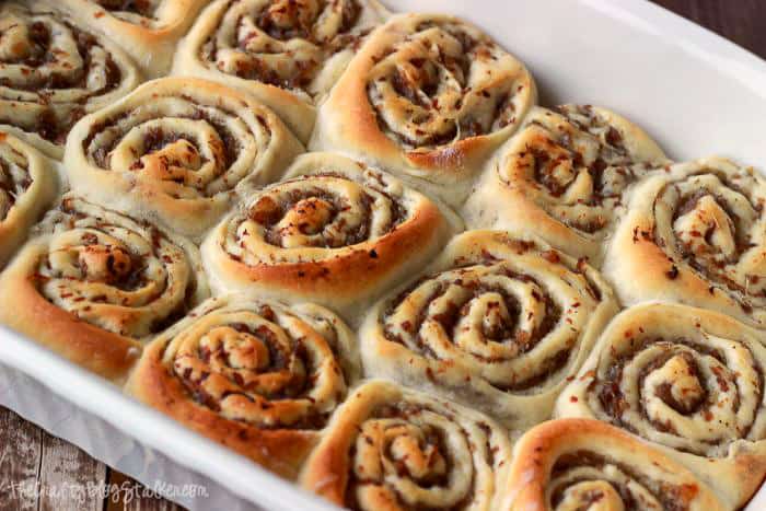 Sausage rolls in a white baking dish.