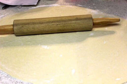 bread dough rolled out with a rolling pin