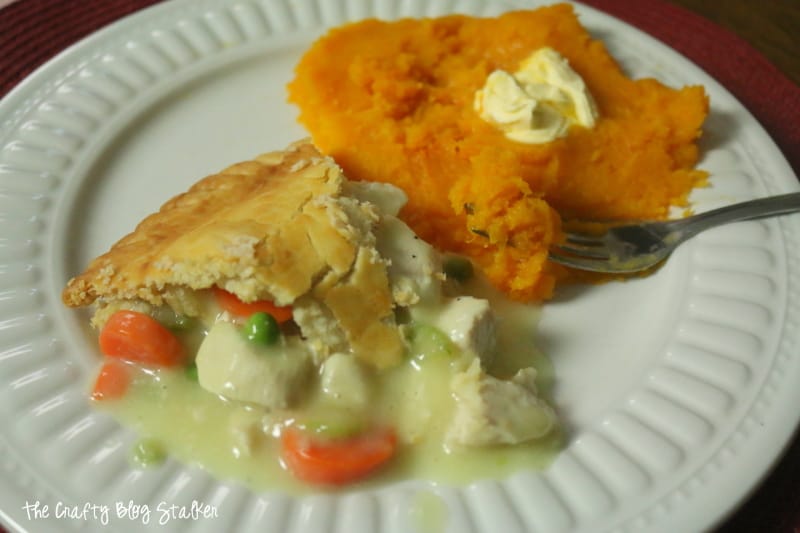 a slice of pot pie and steamed butternut squash as the side