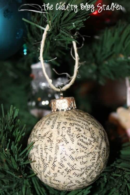 a book page ornament hanging on a Christmas tree