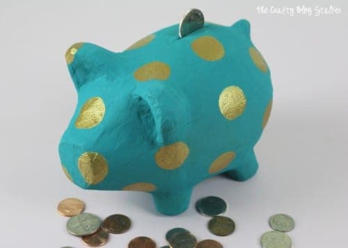 filling piggy bank with coins
