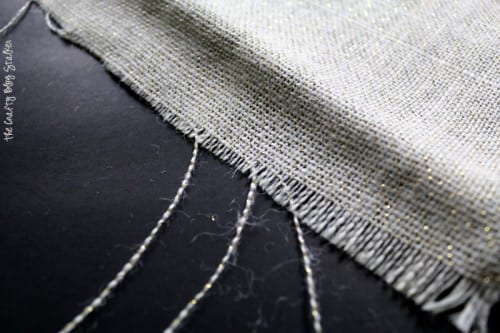 pulling the strings of the burlap to create a fringe