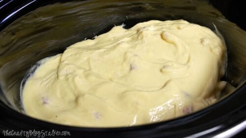 Cream of chicken soup spread over seasoned chicken breasts in a slow cooker before cooking for easy Hawaiian haystacks.