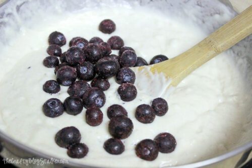 stirring blueberries into pancake mix