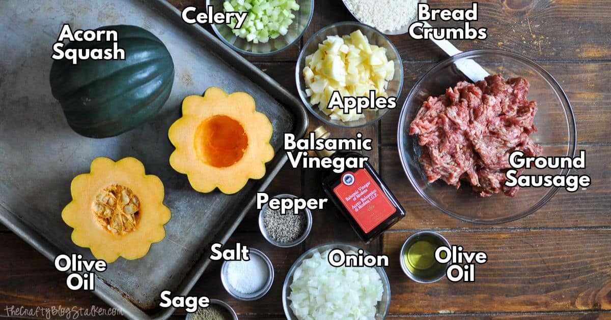 Ingredients for sausage stuffed acorn squash, including acorn squash, ground sausage, apples, celery, onion, breadcrumbs, balsamic vinegar, olive oil, and seasonings.