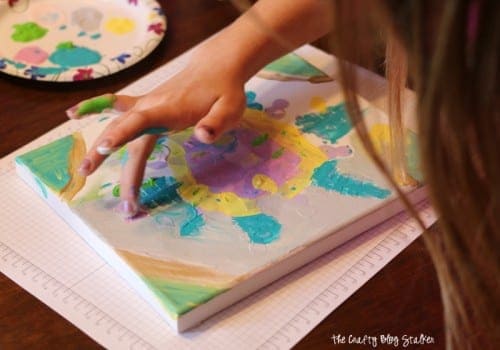 How to Make a Snowflake Finger Painted Canvas, a tutorial featured by top US craft blog, The Crafty Blog Stalker.