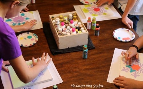 How to Make a Snowflake Finger Painted Canvas, a tutorial featured by top US craft blog, The Crafty Blog Stalker.
