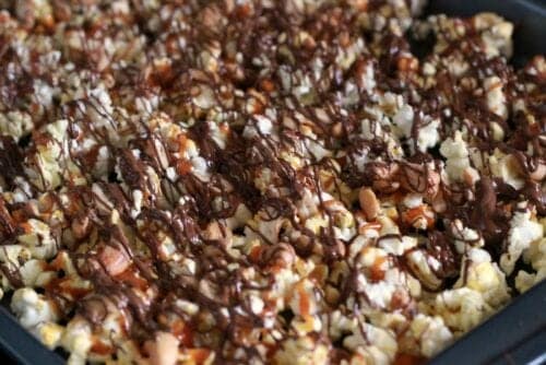 popcorn with melted chocolate drizzled on top