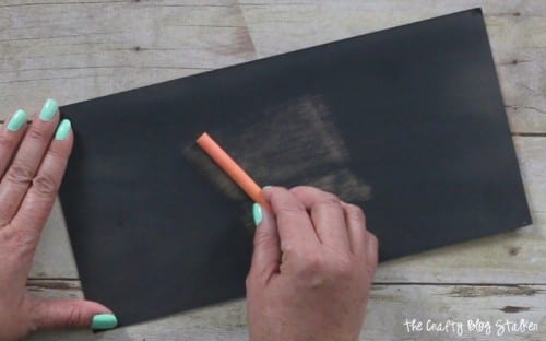 prepping the chalkboard paper by chalking the paper