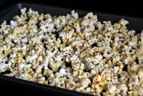 popcorn poured out on a baking sheet