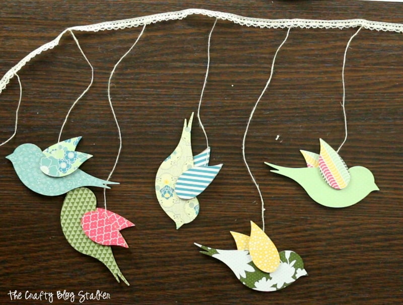 Hanging Bird Garland from the Flock Together Apostrophe S Craft Kit. Easy DIY craft tutorial idea for home decor, nursery decor or party decor.