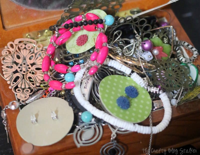 a jewelry box filled with earrings and necklaces without any organization
