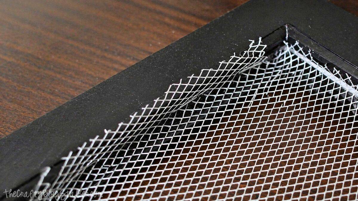 fitting the corner of the aluminum mesh into the corner of the frame