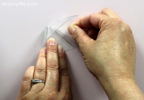 using tape to attach the plastic sheet shapes