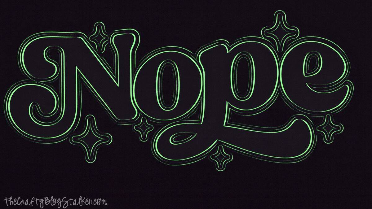 Hand-lettered graphic design on a t-shirt featuring the word “Nope” in a bold retro style with decorative star accents.