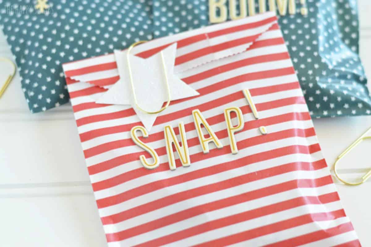 A red and  white striped bag filled with treats.