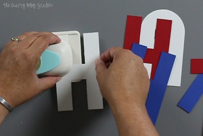 Punching link holes into the left and right side of the paper letter.
