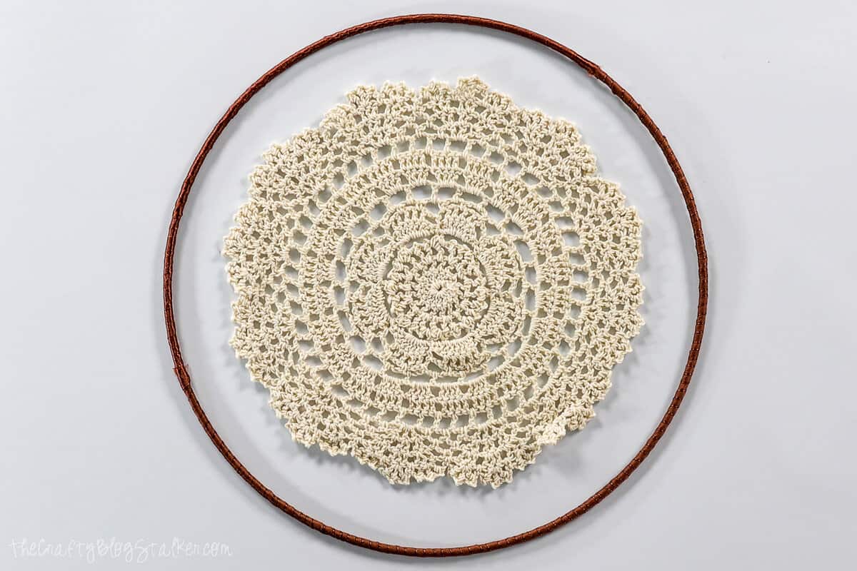 a crocheted doily in the center of a ring