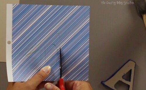 cutting out the tracing with a pair of scissors
