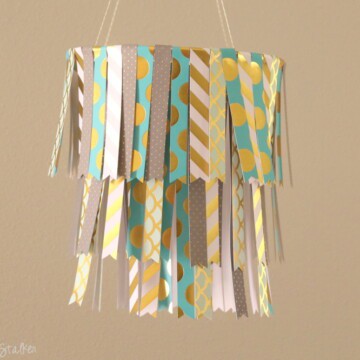 Create a fun DIY Hanging Paper Mobile by following this simple tutorial. Use your favorite pattern paper to match your home decor or party decor.