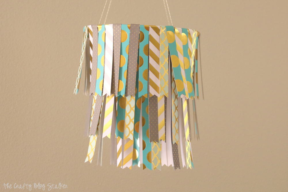 Create a fun DIY Hanging Paper Mobile by following this simple tutorial. Use your favorite pattern paper to match your home decor or party decor.