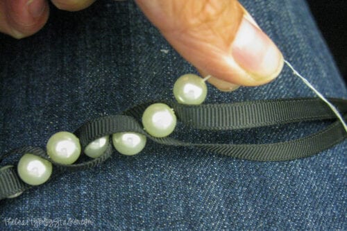 braiding the pearls into the ribbon
