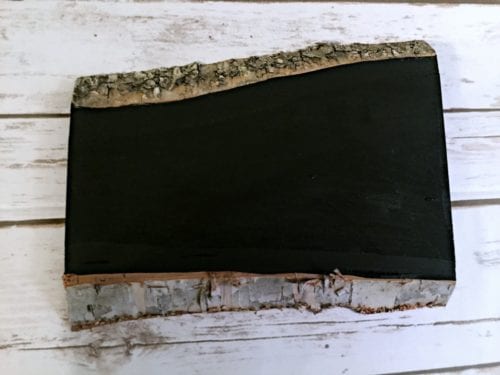 a sliced wood plank painted black