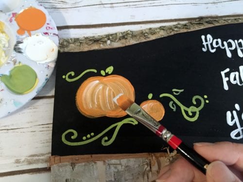 adding highlights to a painted pumpkin sign