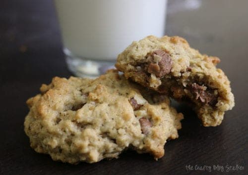 two oatmeal cookies with chocolate milk and a glass of milk