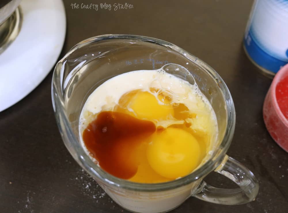 In a liquid measuring glass, add evaporated milk, lemon juice, vanilla, and eggs. Stir.