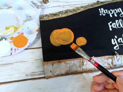 painting a pumpkin with a flat brush