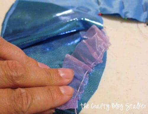 image of sewing gathered ribbon onto the mermaid tail