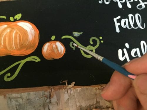 painting pumpkin flourishes with a liner brush