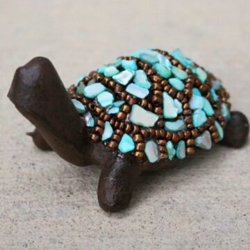 Cute beaded turtle with bronze seed beads and crushed aqua pieces.