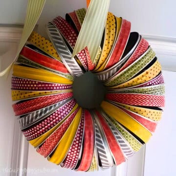 Fall wreath made with mason jar lids and washi tape.