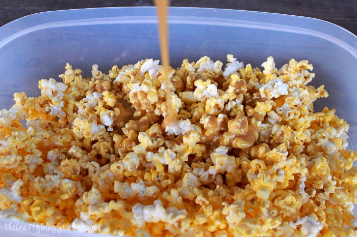 pouring the caramel sauce on the popcorn